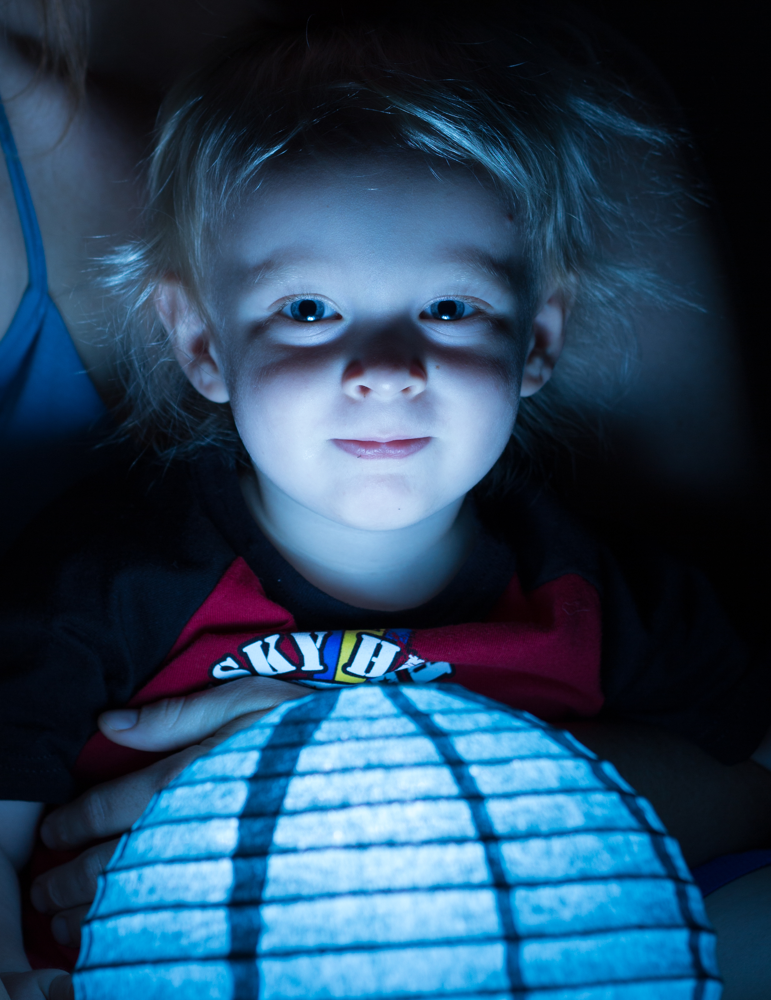 Paper lamp illuminating young child's face